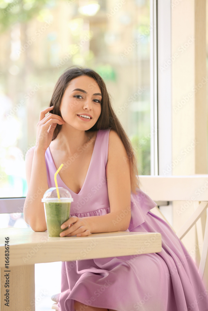 Romantic young lady enjoying tasty smoothie in cafe Romantic young lady enjoying tasty smoothie in cafe