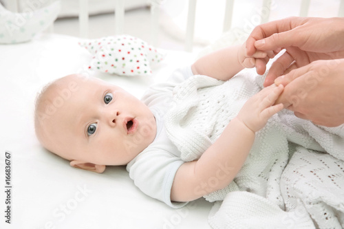 Lovely baby lying in cradle...