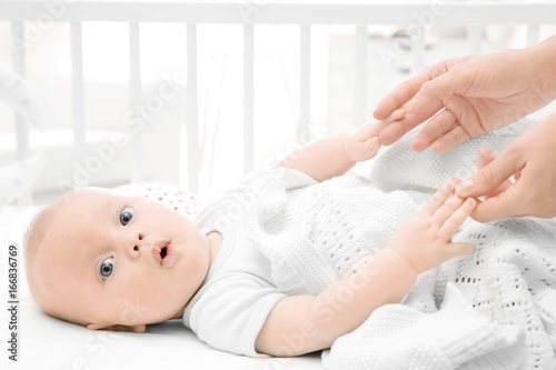 Lovely baby lying in cradle...