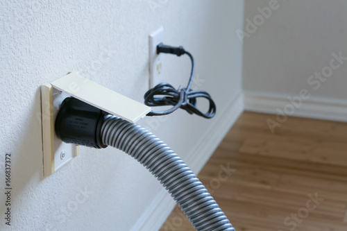 Central vacuum cleaner hose connected to the wall. photo