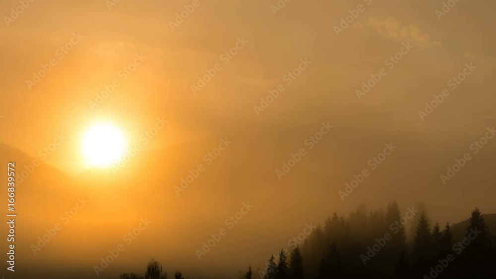 Brilliant sunny dawn above flowing cloud waves, red sun disk time lapse Brilliant sunny dawn above flowing cloud waves, red sun disk time lapse