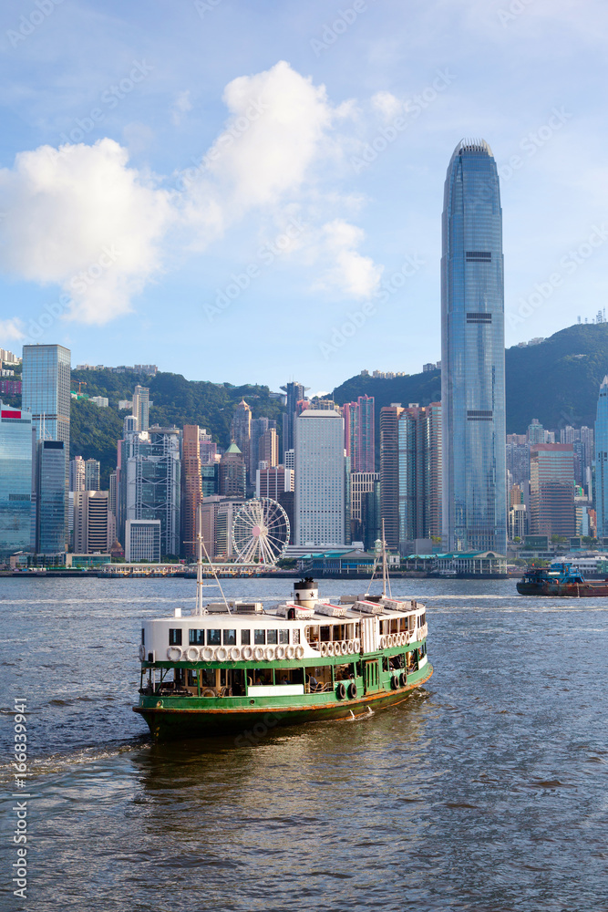 Obraz premium Ferry Crosses Victoria Harbor in Hong Kong
