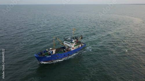 Fishing boat in the Azov Sea at sunset. aerial survey