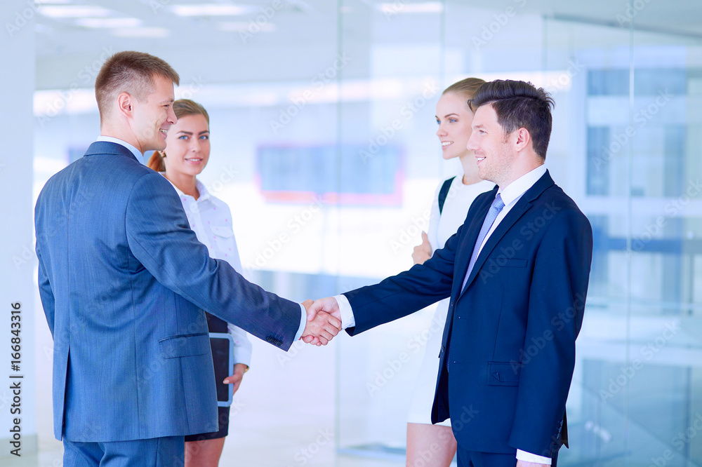 Image of two successful business men shaking hands with each other Image of two successful business men shaking hands with each other
