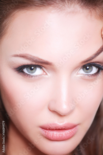 Close up portrait of beautiful young woman face. Isolated on white background. © lenets_tan