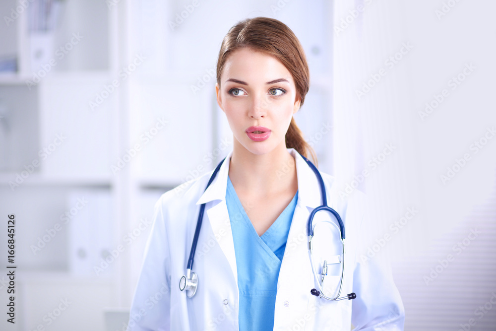 Portrait of young woman doctor with white coat standing in hospital Portrait of young woman doctor with white coat standing in hospital