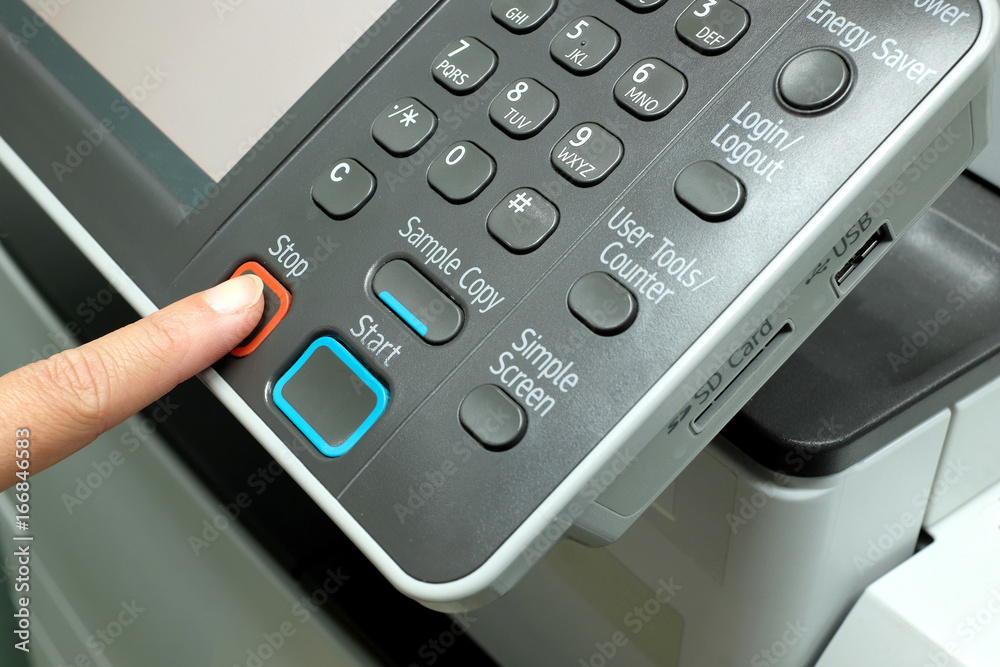 Finger pressing stop button on photocopy Finger pressing stop button on photocopy