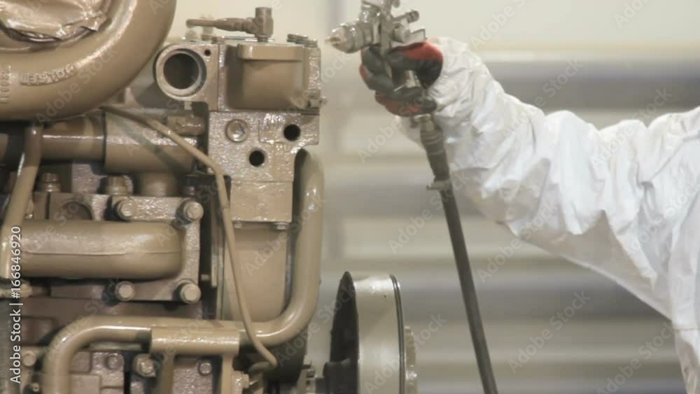 Worker painting with a spray gun. Heavy industry - industrial painting. Worker painting with a spray gun. Heavy industry - industrial painting.