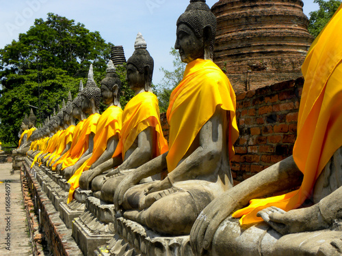 Buddhist Temple statues in golden yellow cloth at Ayutthaya Thailand