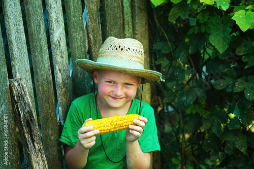 boy holding corn in his hands .Natural healthy food