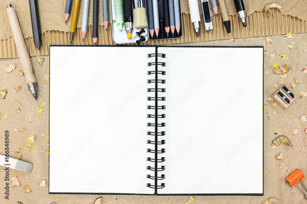 blank sketchbook and pencils for drawing on brown artistic background top  view Stock Photo