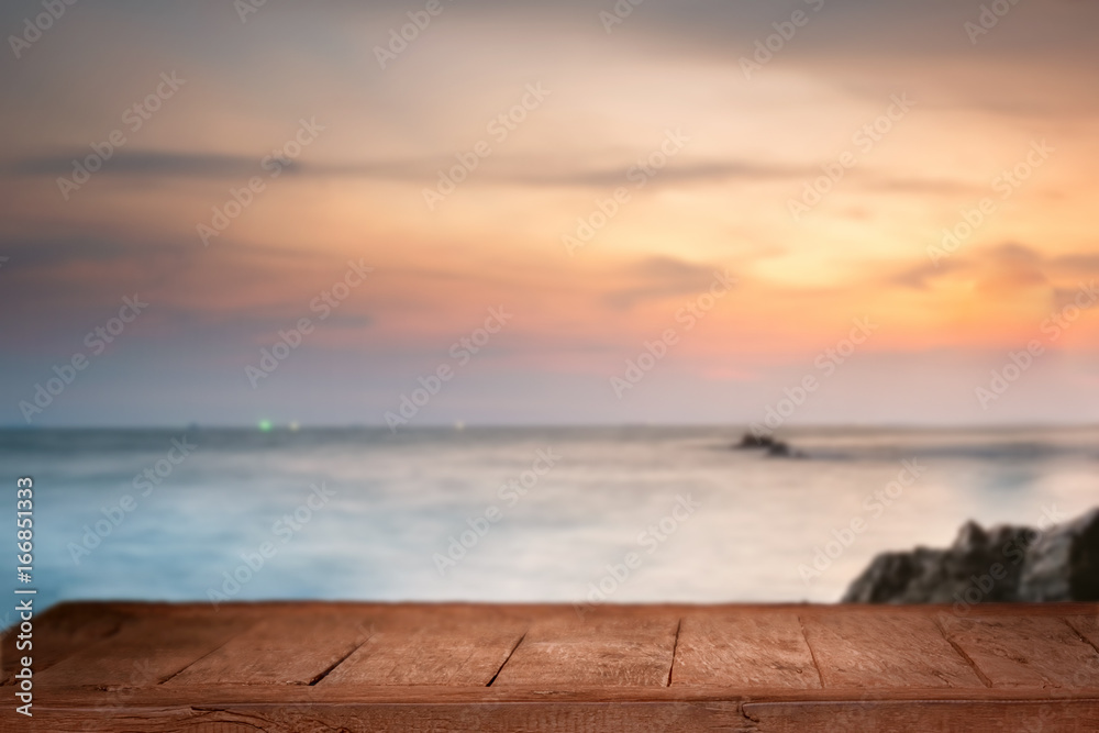 Empty Top of wood table with blurred sea and beach background. For Product display montage. Beach in summer Concept. Empty Top of wood table with blurred sea and beach background. For Product display montage. Beach in summer Concept.