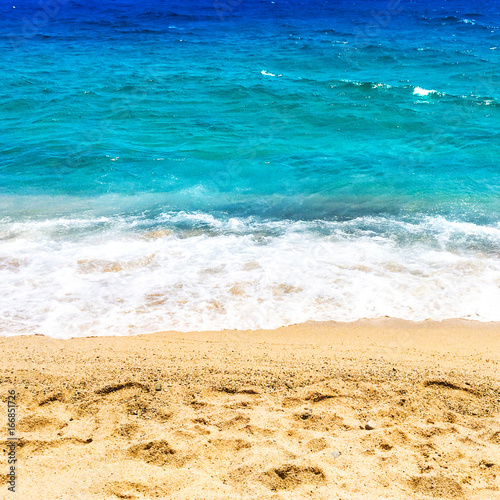 Empty Beach and ocean as background with copy space. Sandy beach, blue sky and sea. Summer relax concept.