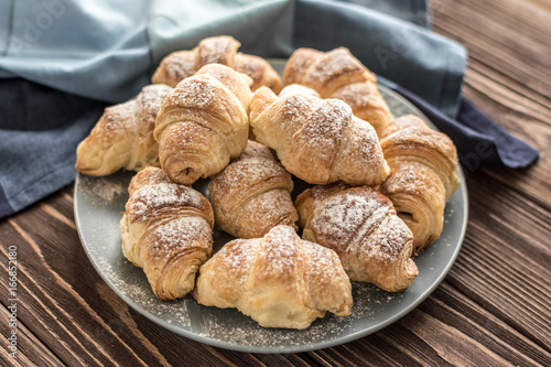  Croissants with chocolate filling on a wooden background