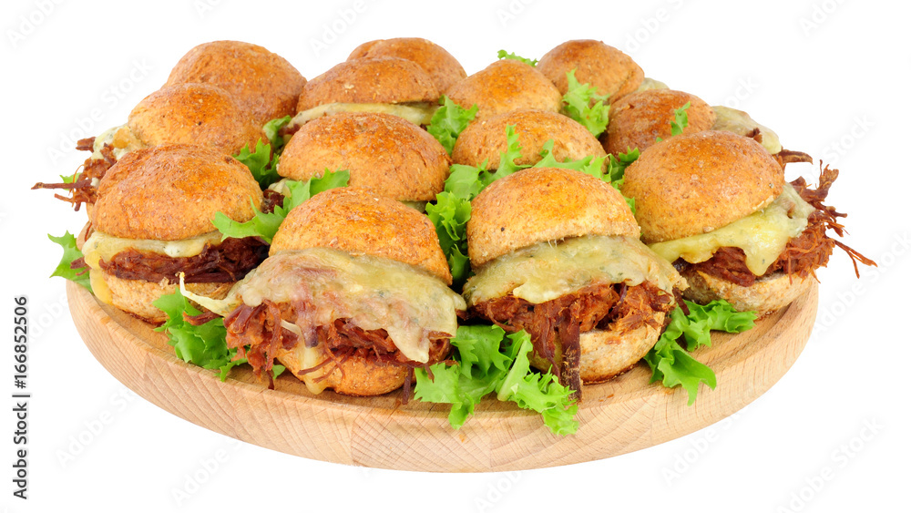 Group of small shredded beef sandwich sliders with melted cheese isolated on a white background