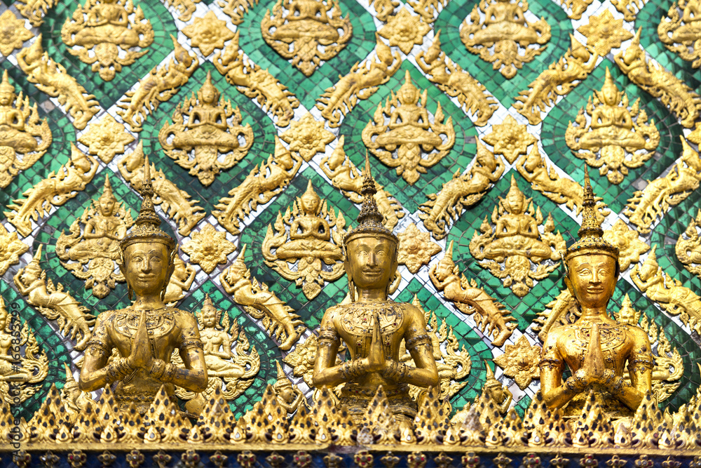 Detail of carvings on temple wall at Wat Phra Kaew, the Temple of Emerald Buddha in Bangkok, Thailand