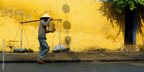 street seller in the street of hoi an