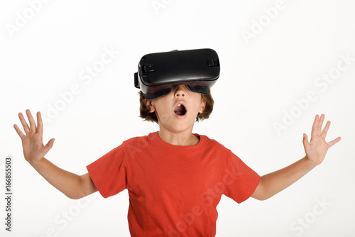 Little girl looking in VR glasses and gesturing with his hands.