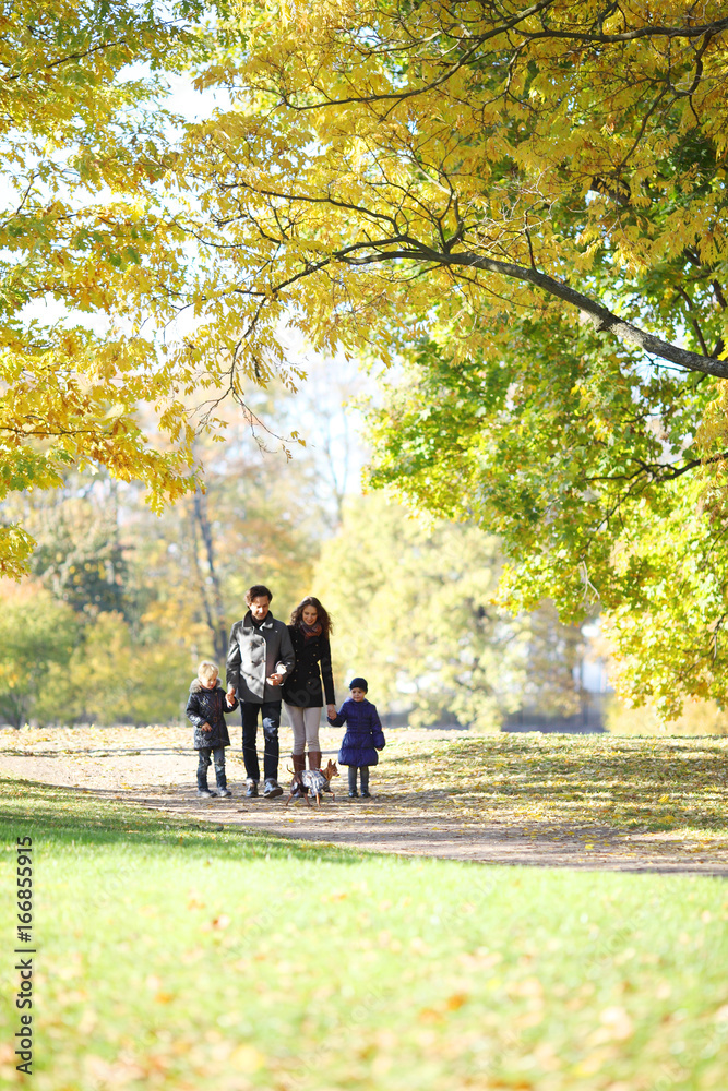 Fototapeta premium Family with children walking in autumn park