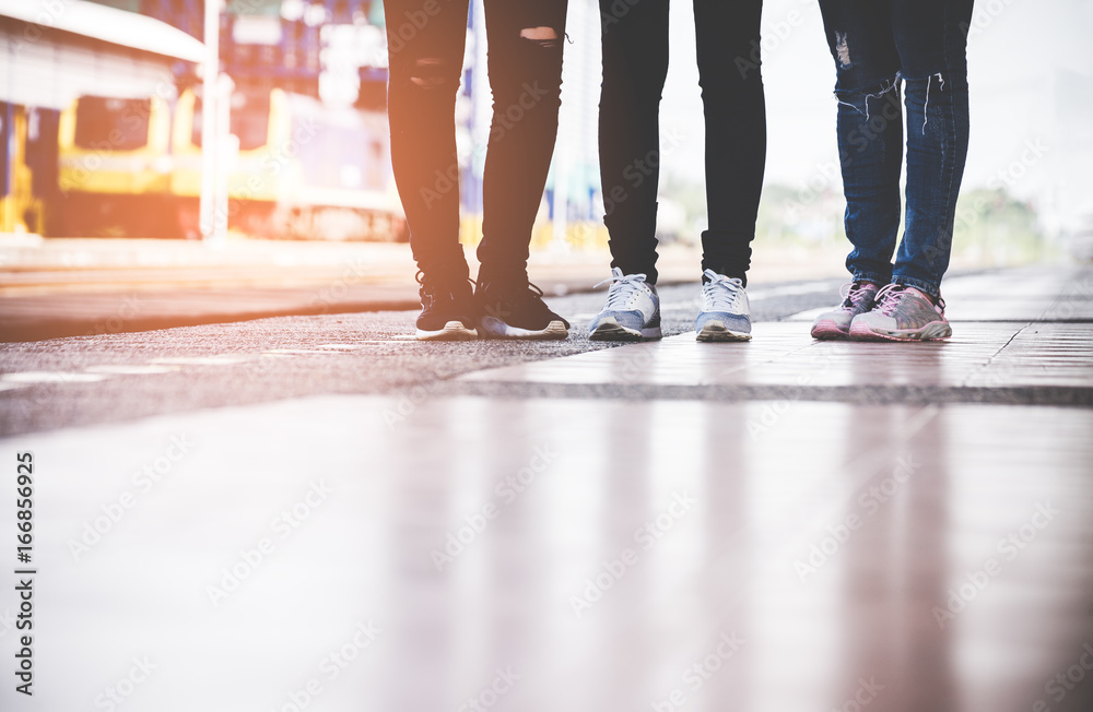 Close up legs group of asia women traveler and tourist traveling backpack holding map and waiting in a train station platform. Travel Concept.. Close up legs group of asia women traveler and tourist traveling backpack holding map and waiting in a train station platform. Travel Concept..