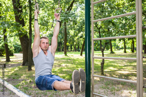 young street workout man exercise in a park