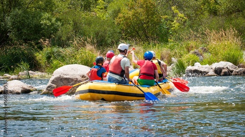 Rafting along the rough river rapids. Extreme vacation in nature.