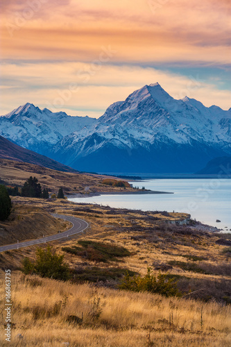 Colorful sunset scenery of Aoraki Mount Cook national park in autumn in south island, New Zealand. Snow moutain with lake and road.