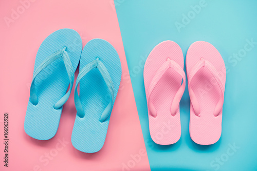 pink and blue sandals on pink and blue pastel background. Lover and Summer concept with copy space.