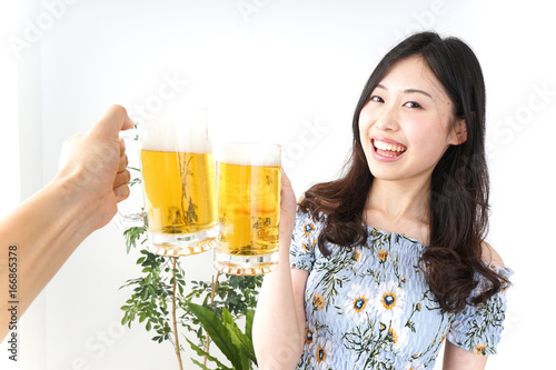 Young woman drinking beer outside