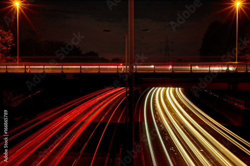 Red and white light trails left by night time traffic. 