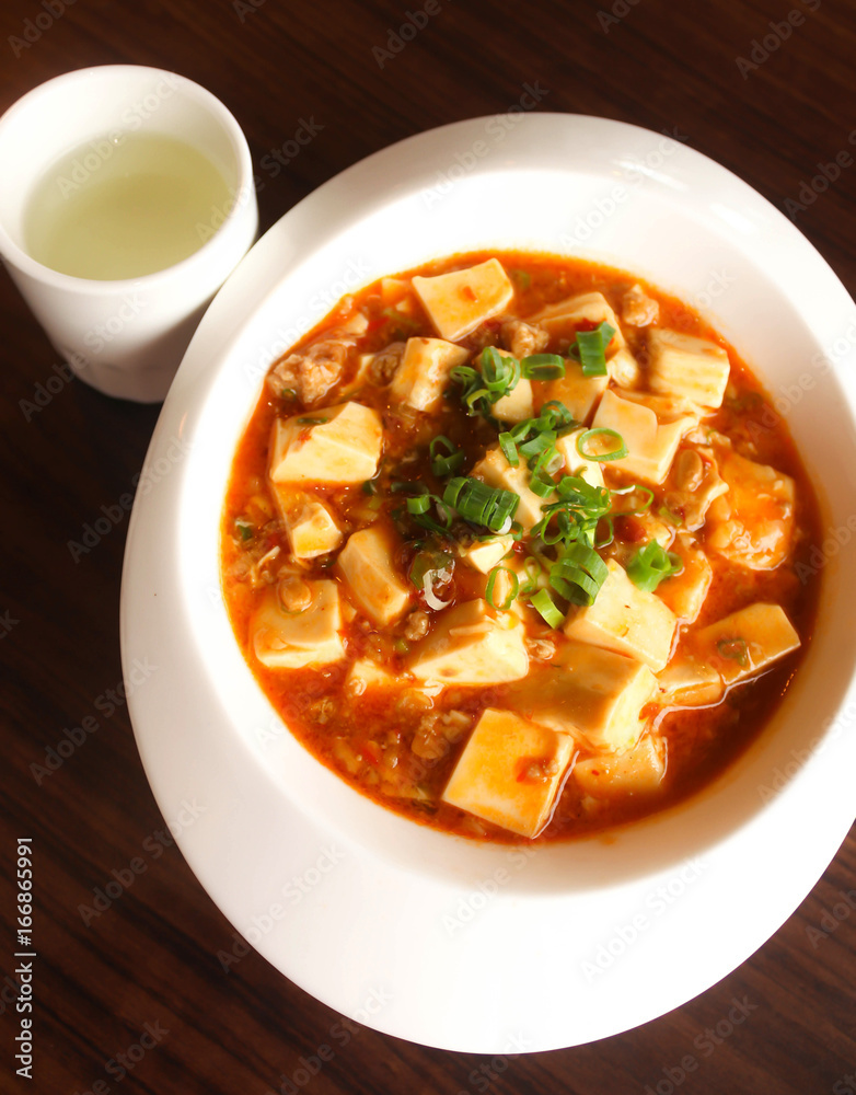 Chinese Food,Mapo doufu Chinese in white dish with tea cup