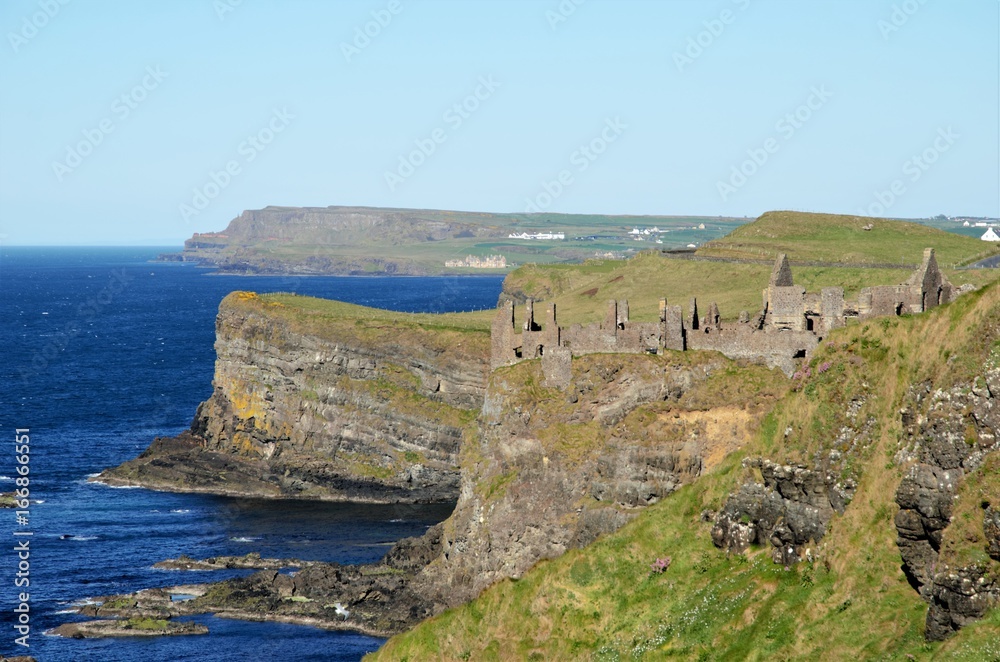 Long shot of the ruins of Dunluce Castle in the County Antrim in Northern Ireland, UK