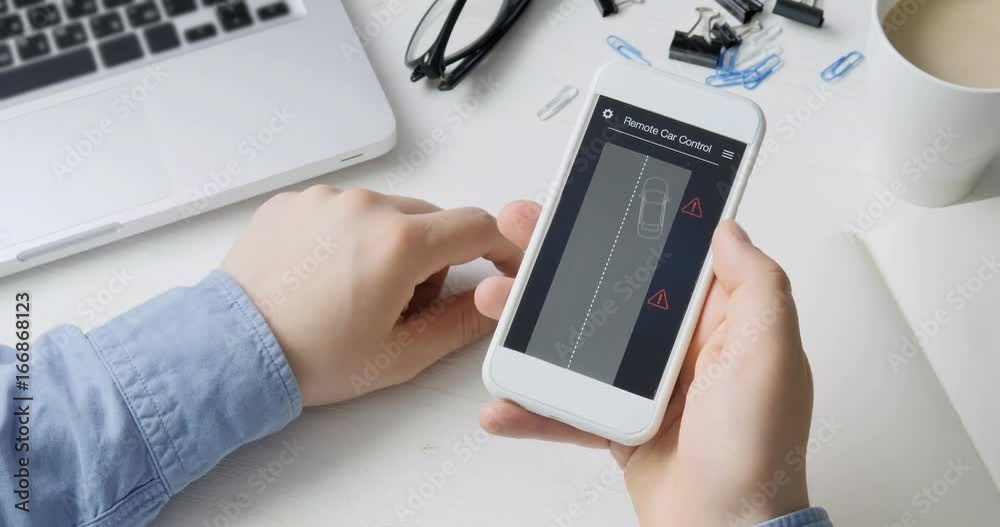 Man remotely parking his car. Car remote control using smartphone application fictional interface. Man remotely parking his car. Car remote control using smartphone application fictional interface.