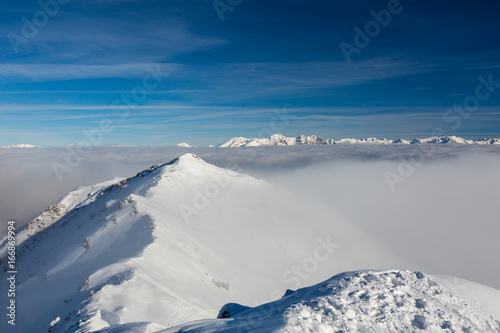 Snowcapped Mountain Ridge and Clouds © alexbrylovhk