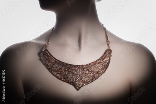 a beautiful handmade necklace on the woman's neck photo