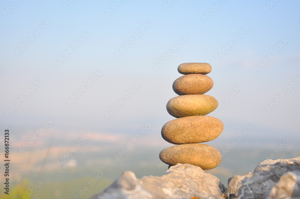 Balanced stone pyramid on mountain. Zen rock, concept of balance and harmony Balanced stone pyramid on mountain. Zen rock, concept of balance and harmony