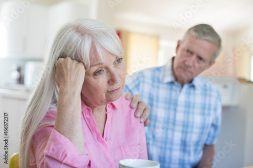 Mature Man Comforting Woman With Depression At Home