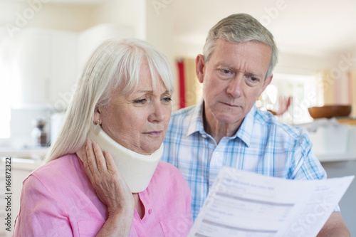 Mature Couple Reading Letter About Wife's Injury