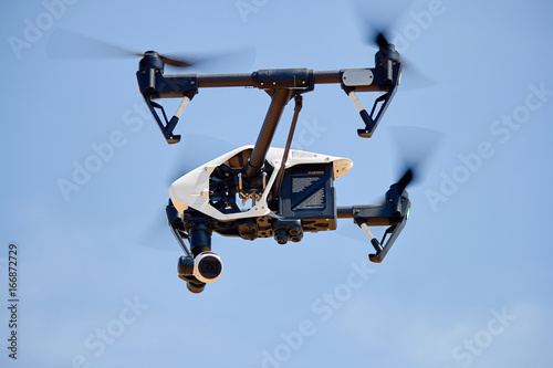 Drone in flight on the blue sky