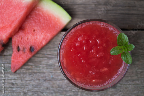 Watermelon smoothies with mint and sleced watermelon on the grey wooden table photo