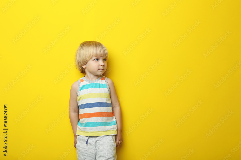 Portrait of little boy on yellow background Portrait of little boy on yellow background