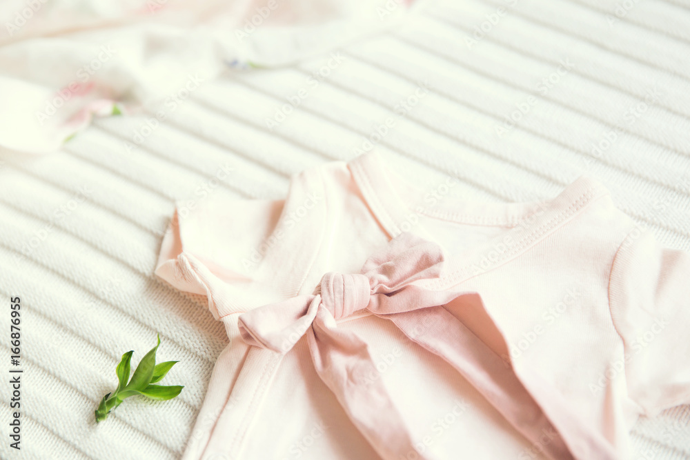 Baby girl clothes. Fabric background.