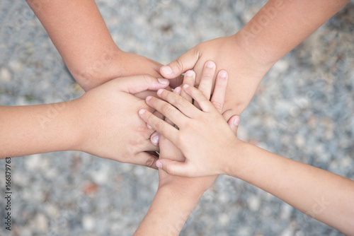 close up of many hands in circle - child connection; teamwork together with Spirit concept.