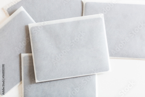 arts and crafts, congratulation, decorating concept. lots of white envelopes made of thin transparent rice paper for craft with black square of heavy stock cardboard