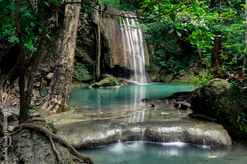 Teal and clear water of the Erawan Waterfall in Kanchanaburi, Thailand. 