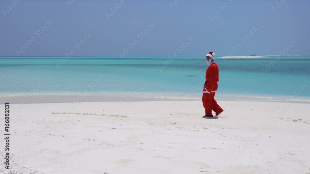 Man in Santa Claus costume on sandy tropical beach. Christmas and New Year celebration on Maldive island
Man in Santa Claus costume on sandy tropical beach. Christmas and New Year celebration on Maldive island