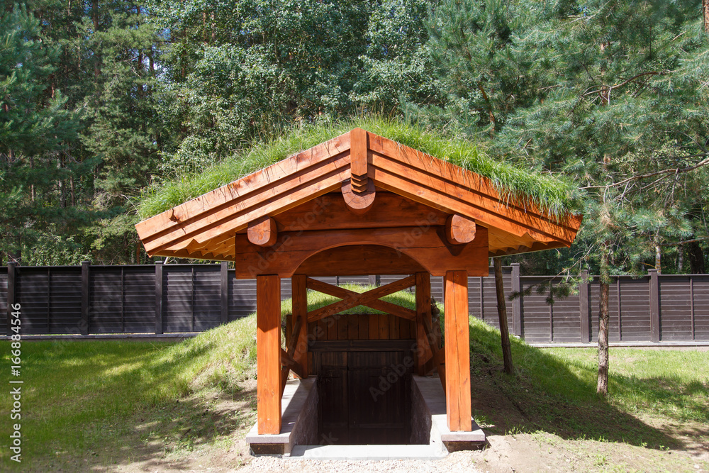 Entrance to the wine cellar with roof covered by grass. Ecology natural concept. Entrance to the wine cellar with roof covered by grass. Ecology natural concept.
