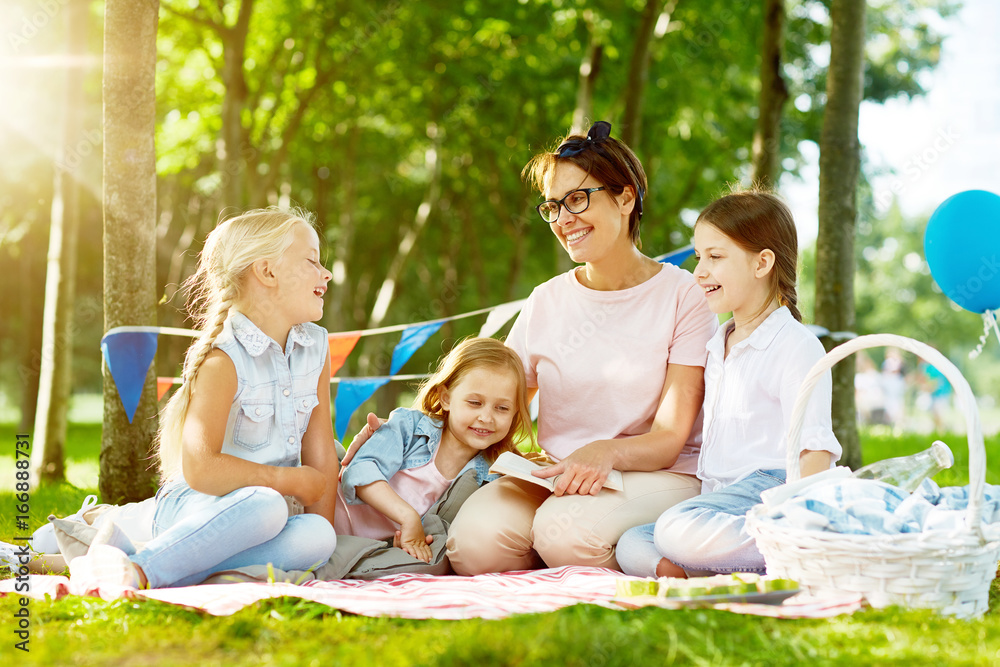 Three adorable girls and their teacher talking or discussing story in natural environment Three adorable girls and their teacher talking or discussing story in natural environment