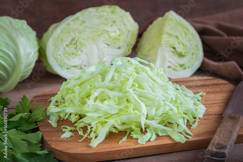 Fresh shredded cabbage on wooden cutting board
