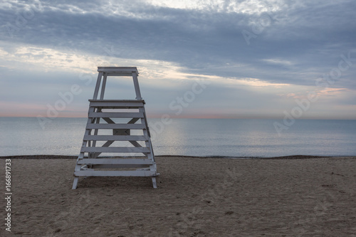 Lifeguard stand on beach with calm water